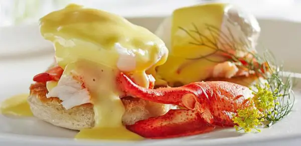 Delectable eggs Benedict with lobster claw meat on the side