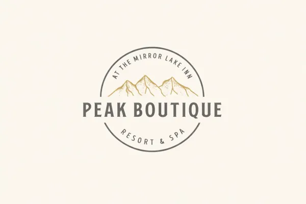 A logo badge split by a mountain and the words Peak Boutique and ringed with At the Mirror Lake Inn Resort and Spa