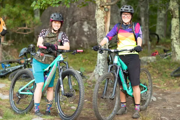Smiling faces on matching teal bikes