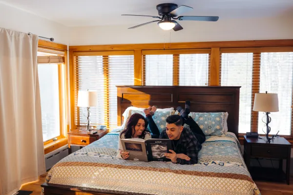 Enjoying the spacious bedroom, walled with windows at Algonquin Mountain Chalet