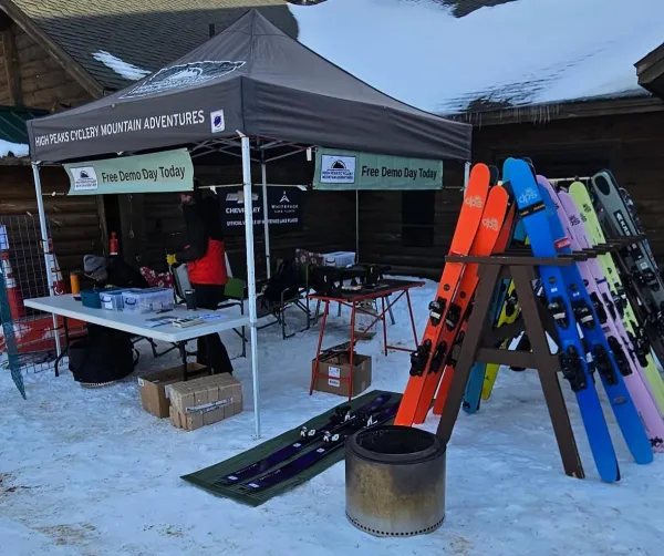 Pop-up tent with tables surrounded by skis