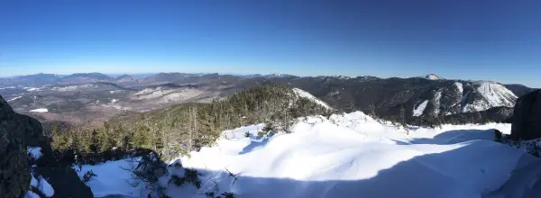 The view of mountains from a snow summit
