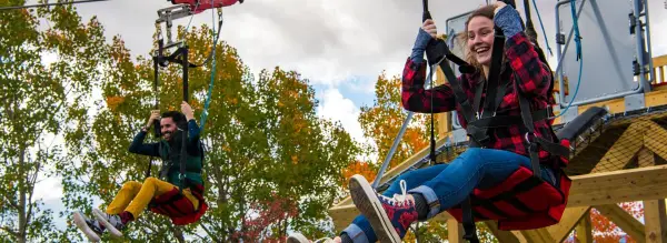 A couple smiles as they start the zipline