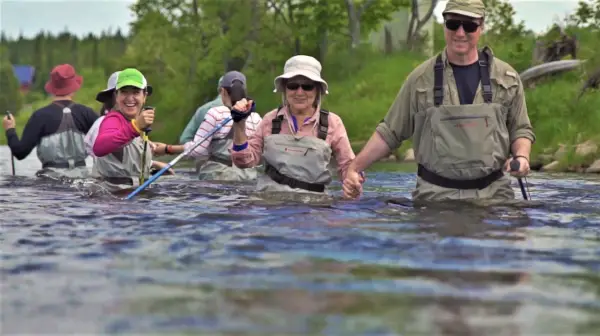 Group wading through river