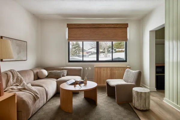 The sitting area of one of the suites with a view of the fresh snow out the window.