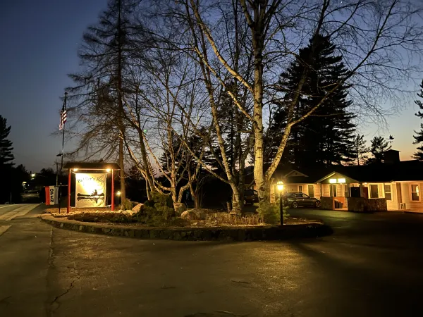 warm lights glow outside the property at dusk