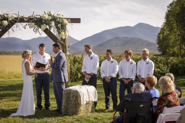 Bride and Groom at the alter with groomsmen and mountains surrounding.