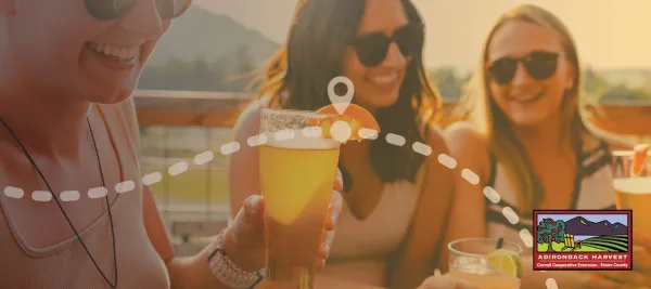 A group of friends share beers at an outdoor table. 