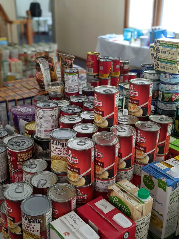 Cans of food and dry goods stacked on a table