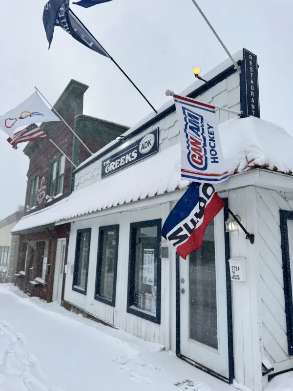 The exterior of the Greeks ADK blanketed in fresh snow