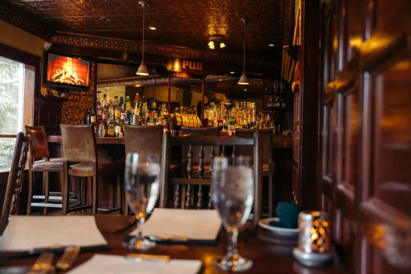 The Interlaken Inn bar area with set table with water glasses in foreground