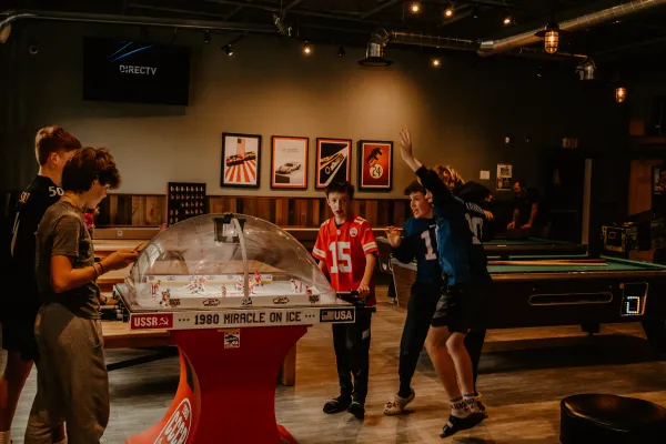 boys play the 1980 miracle on ice theme fooseball hockey game.  Photo Credit to A. Kelly.