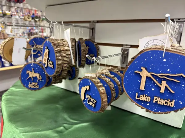 Lake Placid themed log cookie ornaments with ski jumps and people riding horses