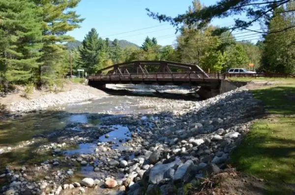 A metal bridge over a rocky river
