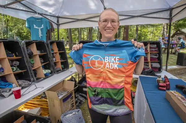 Event participant holds up race jersey