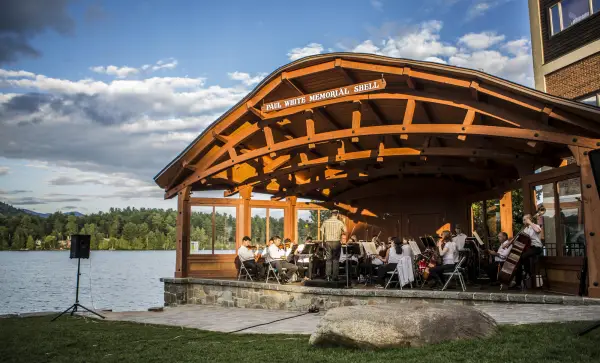 Sinfonietta playing in a lakeside bandshell on a summer day