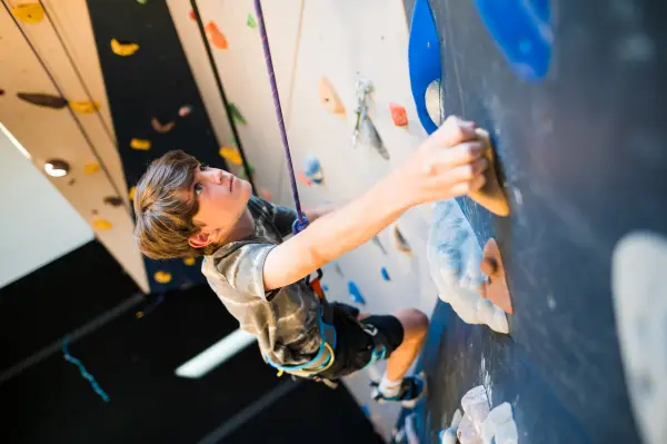Child climbs wall at Rock Climbing Center