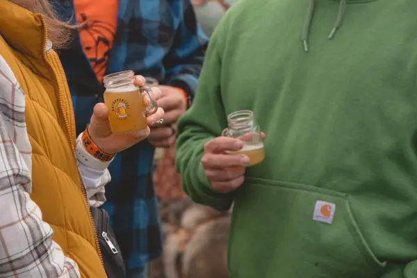 Close up of a couple drinking beer samples at OkTupperfest