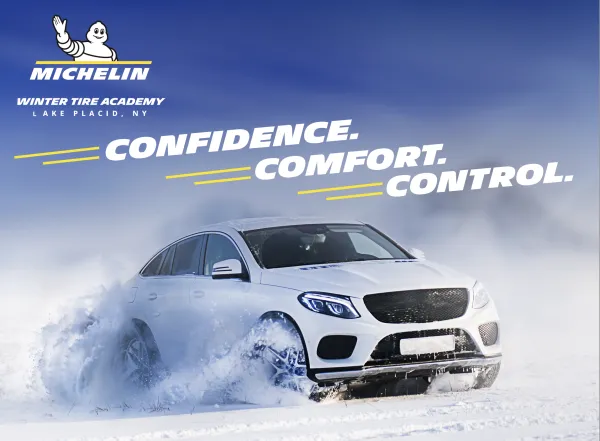 White sedan drives through snow with Confidence, comfort, & control above in bold text & Michelin Winter Tire Academy logo