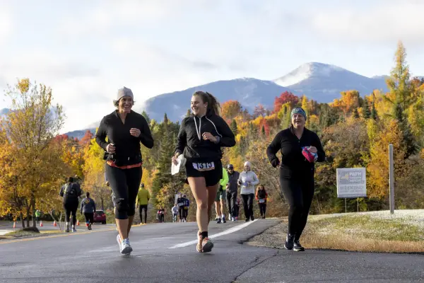 Trio of runners during race with mountains in background