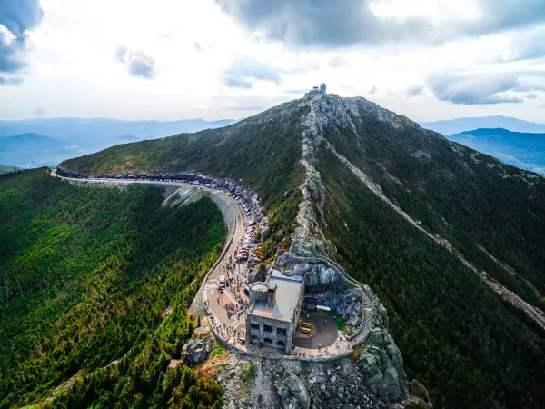 A pointy peak with a castle and road