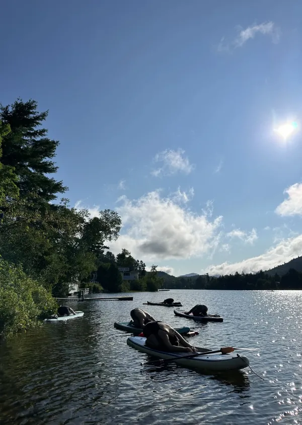 People participating in SUP yoga on Mirror Lake