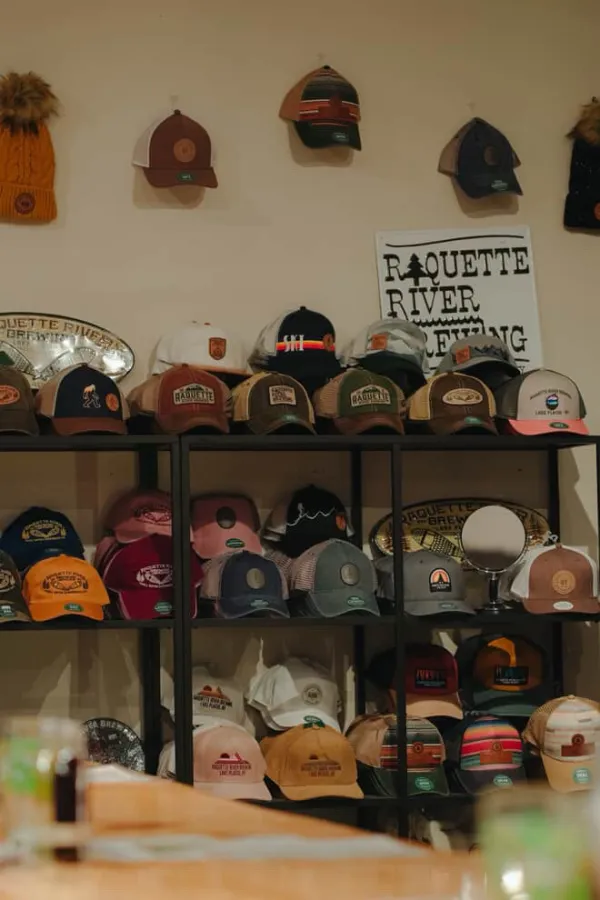 A wall full of branded caps