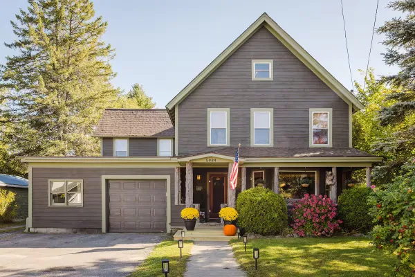 The front yard and entry way with garage and covered porch of Sentinel House.