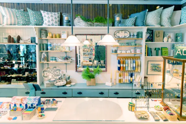 The front counter of The Birch Store with candles, jewelry and baby blue accents