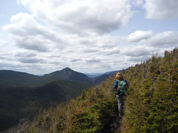 A hiker taking in the views from a summit