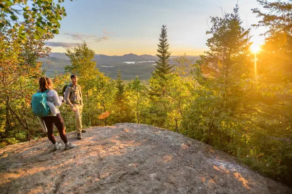 Two people in the last light on a mountain