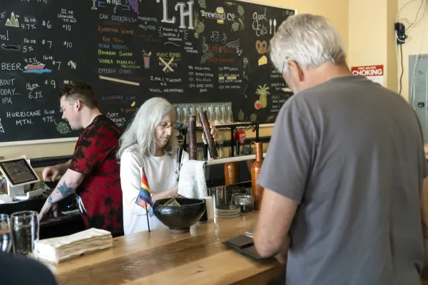 A man checks out at a bar during the day. 