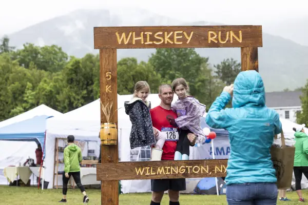 Family taking photo with Whiskey Run photo frame