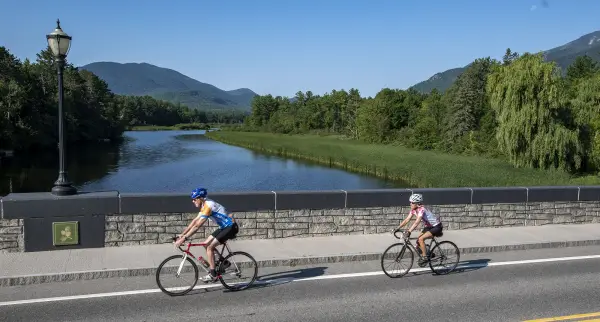 Cyclists crossing bridge over Ausable River