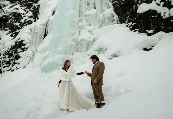 Ice flows behind a bride and groom