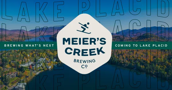 The Meier's Creek hexagon with a skier and an image of Lake Placid as the background