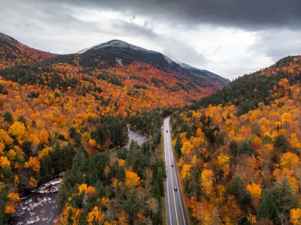 An aerial view of a mountain pass road in the fall