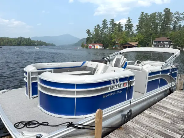 A blue pontoon boat is docked