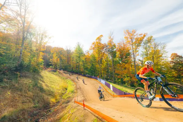 Female athletes bombing down a hilly section of the course.