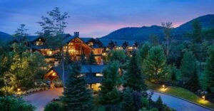 Whiteface Lodge Resort at dusk with outdoor lights illuminated 
