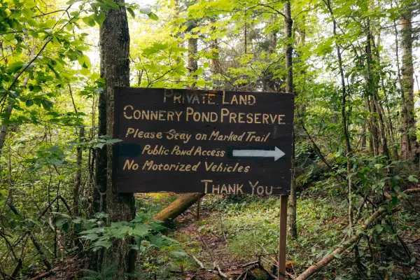 A wooden sign for Connery Pond Preserve