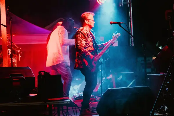 Singer playing guitar on stage
