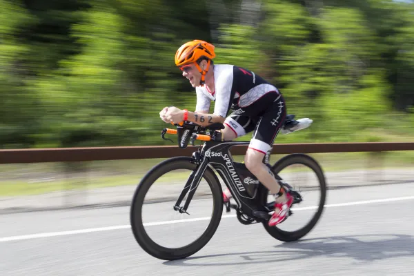 A biker speeds by on a road.