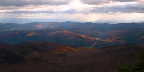 The sunshine through the clouds intensifies the colors.