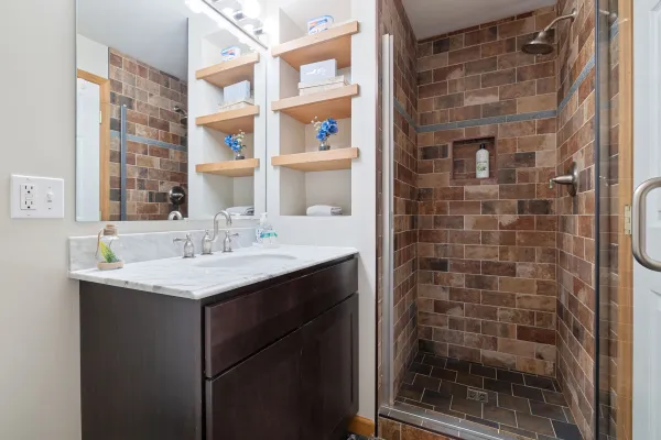View of the vanity and shower on the lower level of Lake Placid Pinehill Townhouse.