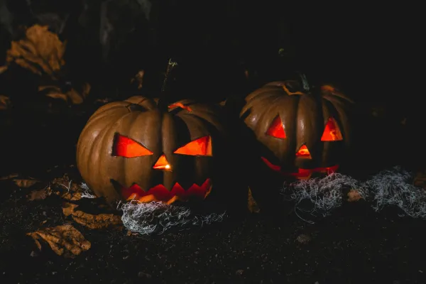 Stock image of two lit jack-o-lanterns inthe dark