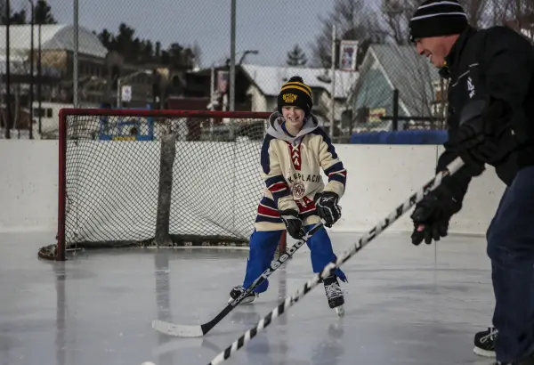 A father son duo play hockey in town.