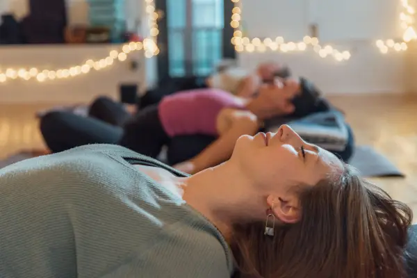 People laying in Savasana after their practice