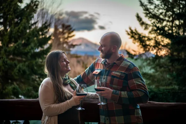 A couple with wine on a winter patio.