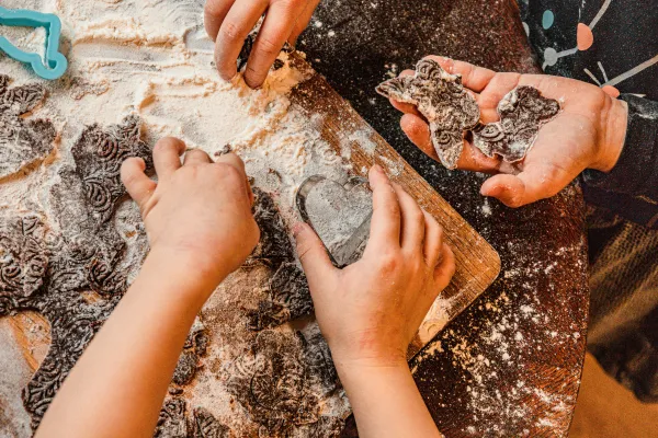 Kids hands playing with rocks and fossils in sand